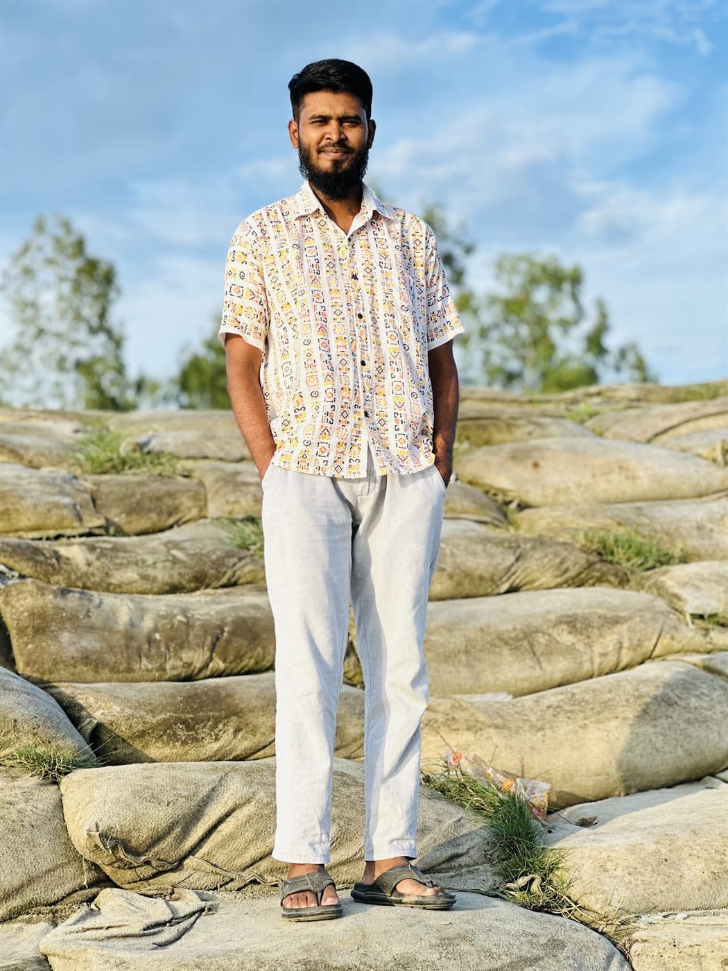 RH Razu standing outdoors under a blue sky