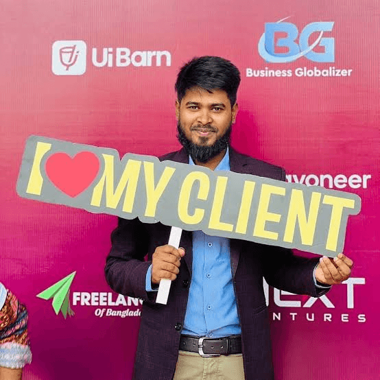 Holding an 'I love my client' sign at a freelancer event